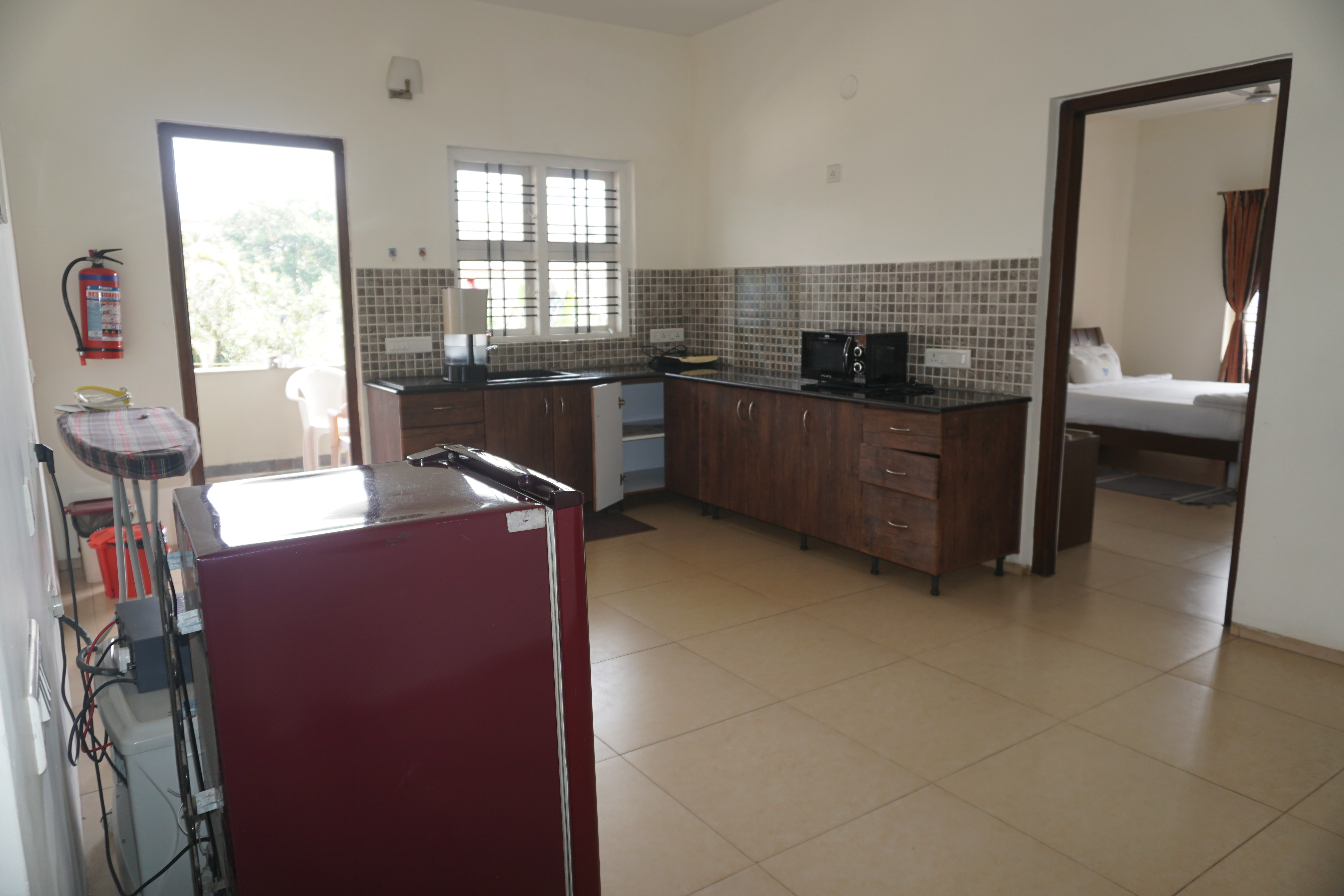 Luxury bedroom with cozy seating at Oleander Suites Coorg