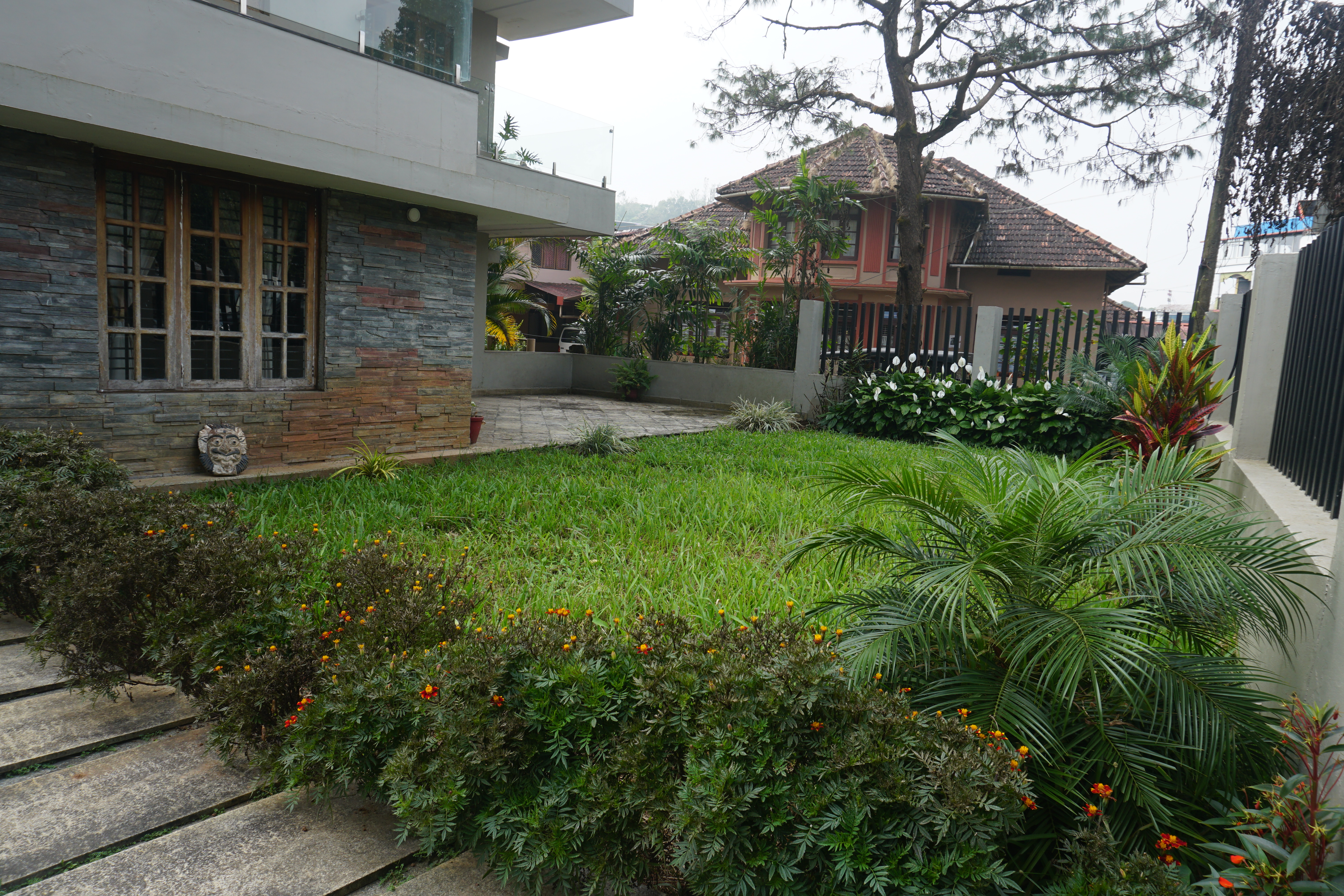 Entrance of Oleander Suites Coorg with lush greenery